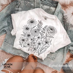 May include: White t-shirt featuring a black and white floral design. The shirt is laid on top of a light blue denim jacket. The words "ORIGINAL DESIGNER" and "digital download" are visible.