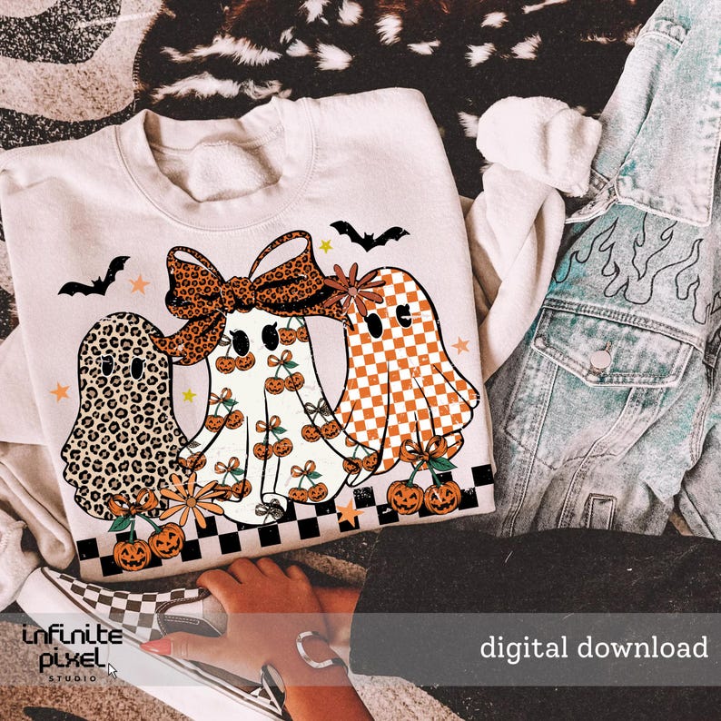 May include: A cream-colored sweatshirt featuring three ghost characters with Halloween-themed designs. One ghost has a leopard print, another has a bow, and the third has a checkered pattern. The design includes pumpkins, bats, and stars. The words "digital download" are visible.