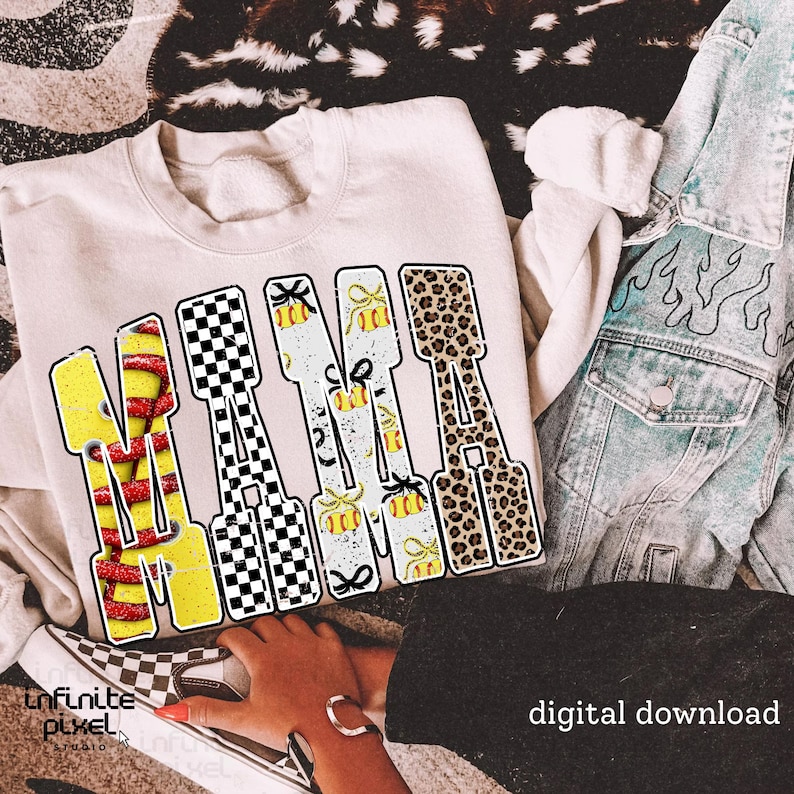 May include: Cream-colored sweatshirt with the word "NANA" in a bold, patterned design. The letters feature a mix of yellow with red stripes, black and white checkered, white with yellow bows, and leopard print. A denim jacket and checkered shoes are also visible.