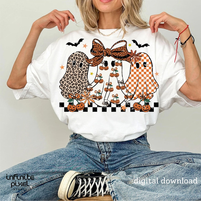 May include: White t-shirt featuring three ghost illustrations with various patterns, including leopard print, cherries, and orange checkered designs. The ghosts are decorated with bows, flowers, and pumpkins. The text "digital download" is visible.