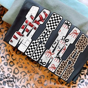 May include: Five decorative hair clips spelling "MOM". Designs include red and white stripes, a black and white checkerboard, baseballs with red bows, and leopard print. The clips are set against a dark grey background.