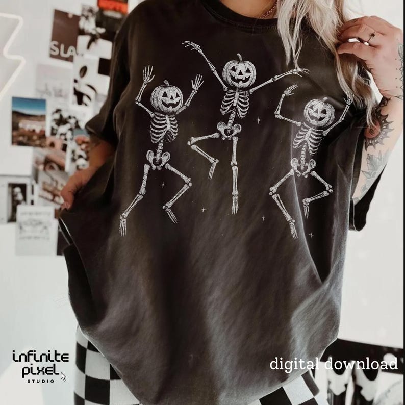 May include: Dark gray t-shirt featuring three dancing skeletons with pumpkin heads. The skeletons are white and have their arms and legs outstretched. The words "digital download" are printed on the bottom right.