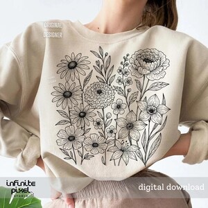 May include: Beige sweatshirt featuring a black and white floral design. The design includes various flowers and leaves. The words "ORIGINAL DESIGNER" and "digital download" are printed on the sweatshirt. The brand name "infinite pixel studio" is also visible.