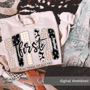 Puede incluir: Una sudadera beige con las palabras "PUT FIRST" en un diseño audaz de patrones mixtos. La palabra "first" está en cursiva. El texto "IN ALL THINGS, PUT GOD FIRST" está debajo. Una chaqueta vaquera y un zapato a cuadros están en el fondo.