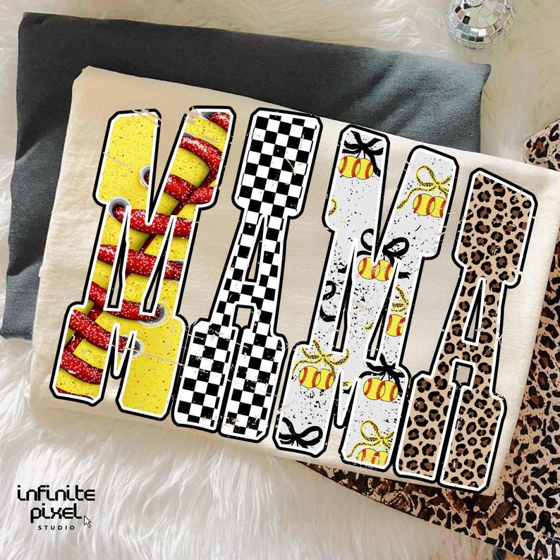 May include: A cream-colored t-shirt with the word "MAMA" in large, stylized letters. Each letter features a unique design: red and yellow stripes, a black and white checkerboard, tennis balls with bows, and leopard print. The Infinite Pixel Studio logo is visible.