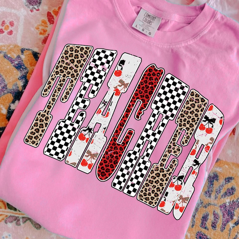 May include: Pink Comfort Colors sweatshirt with the word "PEACHED" in a bold, playful design. The letters feature a mix of leopard print, checkered patterns, and cherry accents, creating a fun and eye-catching aesthetic.