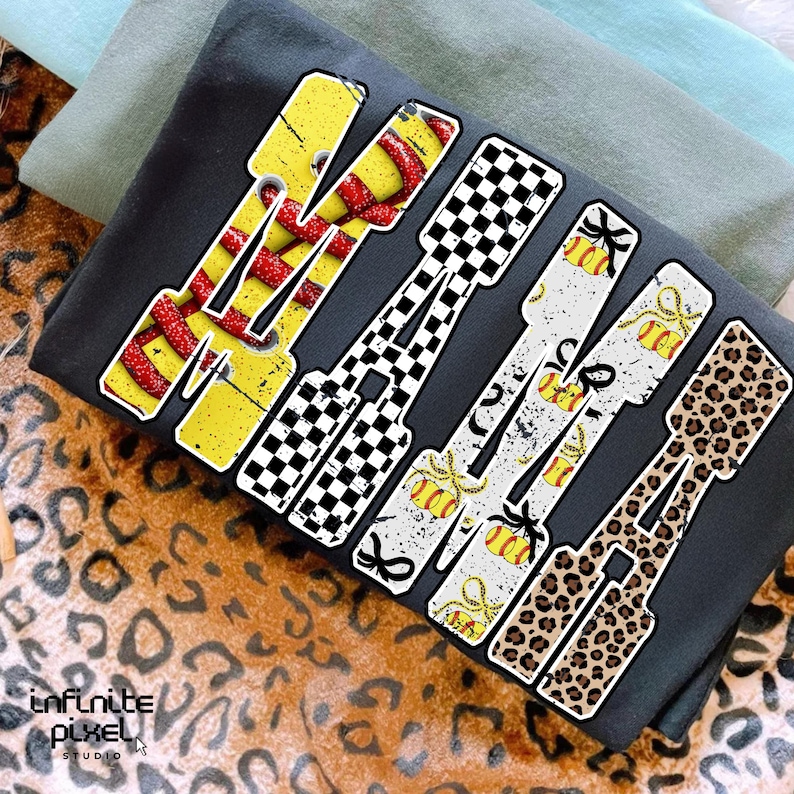 May include: A dark gray t-shirt with the word "WAKE" in a bold, stylized font. Each letter features a unique design: yellow with red snakeskin, black and white checkered, white with gold accents, and leopard print.
