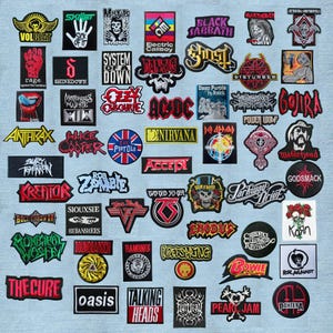 Könnte beinhalten: Eine Sammlung bestickter Stoffaufnäher mit verschiedenen Logos von Rock- und Metalbands sowie grafischen Designs, darunter Namen wie Volbeat, Misfits, Black Sabbath, Iron Maiden, AC/DC, Nirvana, Guns N' Roses und Pearl Jam in verschiedenen Farben.