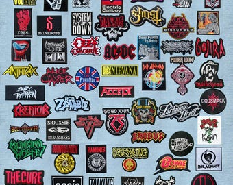 May include: A collection of embroidered fabric patches featuring various band logos and music-related graphics, including names like Volbeat, Misfits, Black Sabbath, Iron Maiden, Rage, Shinedown, System of a Down, Danzig, Ghost, Disturbed, and many others.