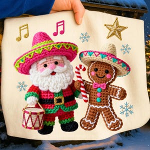 May include: A cream-colored Christmas-themed fabric featuring crocheted Santa Claus and gingerbread man characters wearing sombreros. The Santa holds a drum, and the gingerbread man holds a candy cane. Musical notes, snowflakes, and a star are embroidered on the fabric.