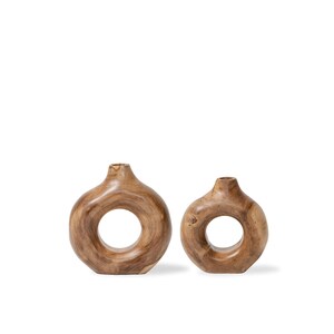 May include: Two wooden decorative vases with a unique circular design. The vases are a warm brown color and have a smooth, natural finish. The vases are of different sizes, with one larger than the other.