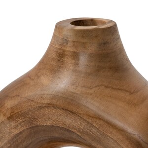 May include: A wooden decorative vase with a unique, open design. The vase is made of light brown wood and has a smooth, polished finish. The vase has a circular opening and a curved shape.