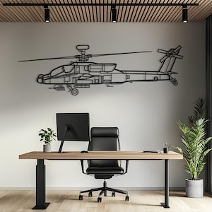 May include: A black metal wall art piece shaped like an AH-64 Apache attack helicopter. The silhouette features detailed outlines of the rotor blades, cockpit, fuselage, landing gear, and tail rotor, mounted horizontally on a plain white wall.