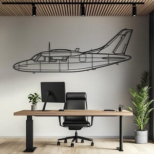 May include: A black metal wall art piece shaped like the silhouette of a twin-engine airplane. The design features clean, minimalist lines outlining the fuselage, wings, tail section, and propeller, creating a flat, open-frame structure.
