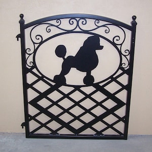 Ornamental iron gate featuring a silhouette of a poodle dog and decorative scroll work
