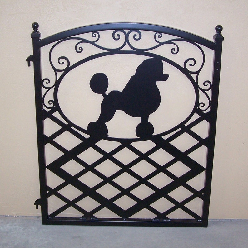 Ornamental iron gate featuring a silhouette of a poodle dog and decorative scroll work