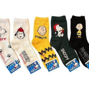 May include: Set of five colorful socks featuring Peanuts characters, including Snoopy, Charlie Brown, and Woodstock. The socks are made of soft, comfortable fabric and are perfect for everyday wear.