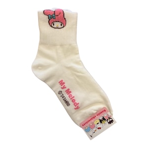 May include: White ankle socks with a pink My Melody character on the front. The socks have a pink and white Sanrio characters tag attached.