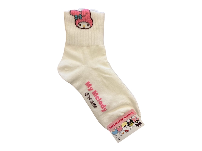 May include: White ankle socks with a pink My Melody character on the front. The socks have a pink and white Sanrio characters tag attached.