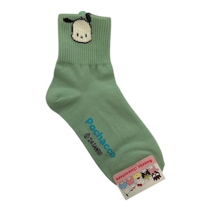May include: Green ankle socks with a cartoon dog graphic and the text "Pochacco &copy;'21 SANRIO" on the side. The socks have a white and black cartoon dog graphic on the front.