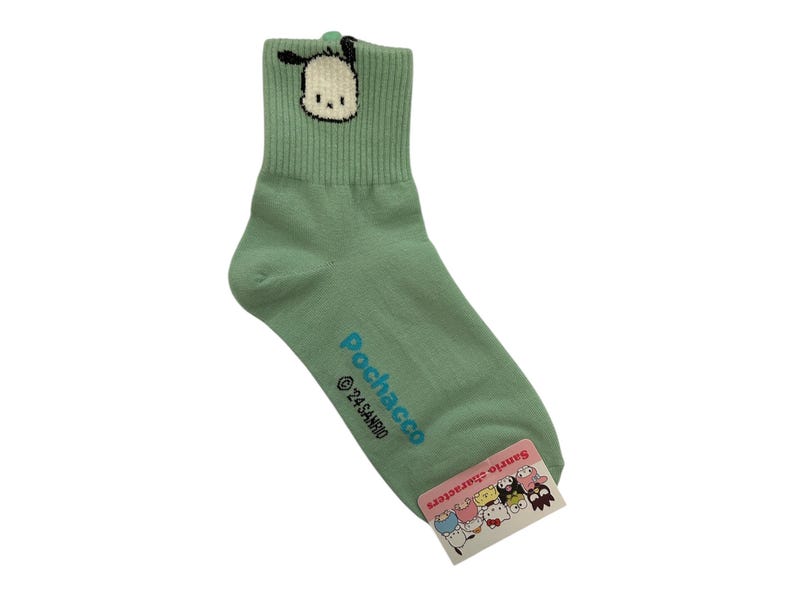 May include: Green ankle socks with a cartoon dog graphic and the text "Pochacco &copy;'21 SANRIO" on the side. The socks have a white and black cartoon dog graphic on the front.