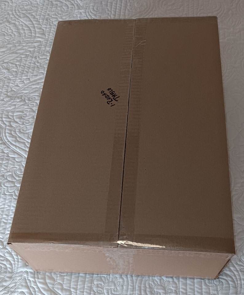 May include: A brown cardboard box with the text "123456 78910" written on it.