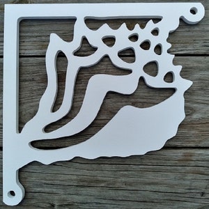 May include: White wooden shelf bracket with a cutout design resembling a seashell. The bracket has a simple, elegant design and would be a great addition to any home decor.