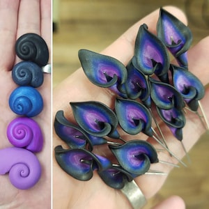 May include: A collection of handmade polymer clay earrings featuring black and purple calla lily flowers. The earrings are delicate and intricate, with a realistic look.