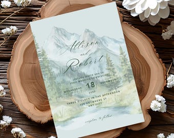 May include: A wedding invitation featuring a watercolor landscape of mountains, trees, and a river. The invitation is light blue with the names "Allison and Robert" in elegant script. The date is December 18, 2030, with the time and location details.