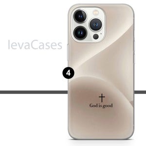 May include: A clear phone case with a beige background and a subtle wave pattern. The case has a black cross and the text "God is good" printed on the back.