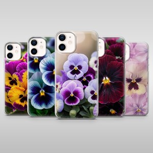 May include: A collection of five phone cases featuring vibrant floral designs. The cases showcase close-up images of pansies in various colors, including yellow, blue, purple, and burgundy. The clear cases allow the floral patterns to be the focal point.