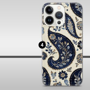 May include: A smartphone case with a navy blue paisley design and floral details on a cream backdrop. The case has a clear, protective design.