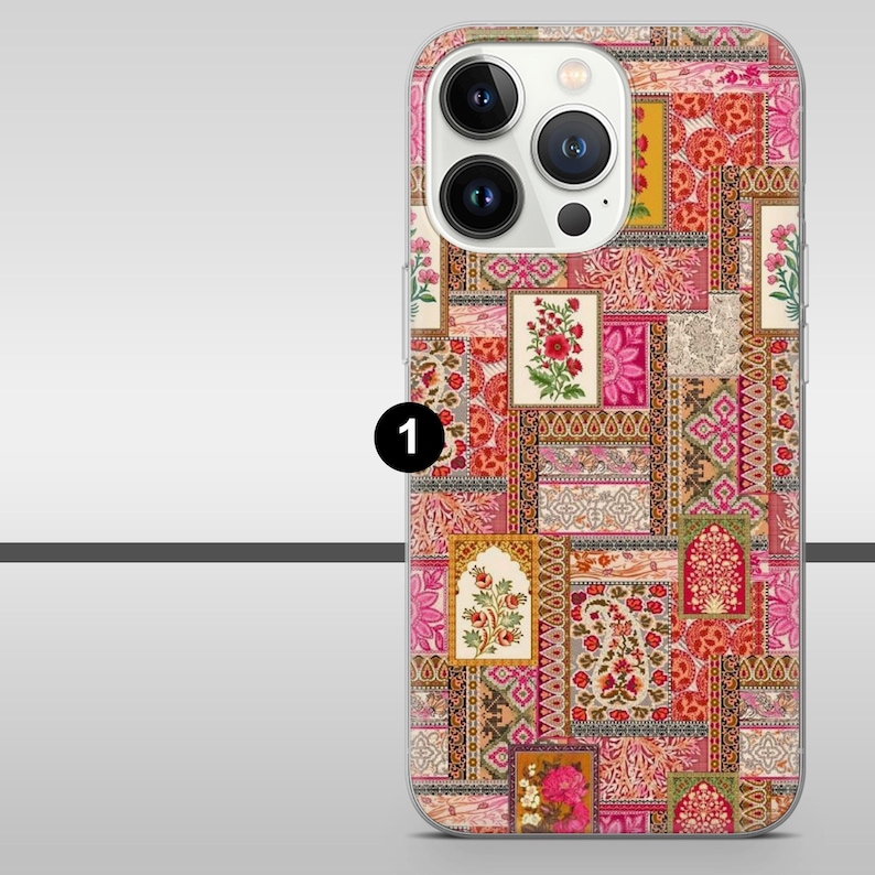 May include: A phone case with a patchwork design in shades of pink, red, and orange. The case features floral and paisley patterns, with a clear camera lens cutout. The overall aesthetic is reminiscent of a vintage textile.