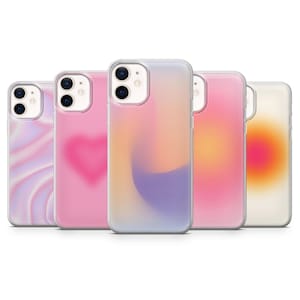 May include: Four different phone cases with abstract designs. The cases are clear and show a pink, purple, orange, and yellow gradient.