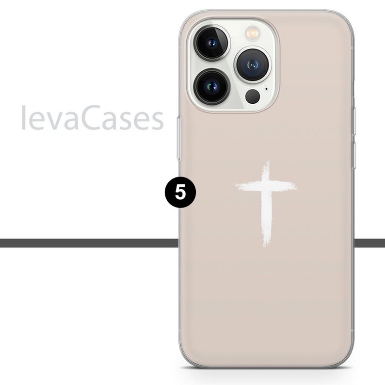 May include: A beige phone case with a white cross design. The case is compatible with iPhone 13 Pro Max.
