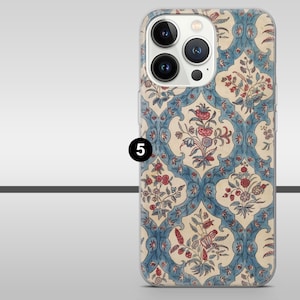 May include: A phone case with a floral design in blue, red, and cream. The pattern features stylized flowers and leaves in a repeating motif. The case has a clear border and a camera aperture.