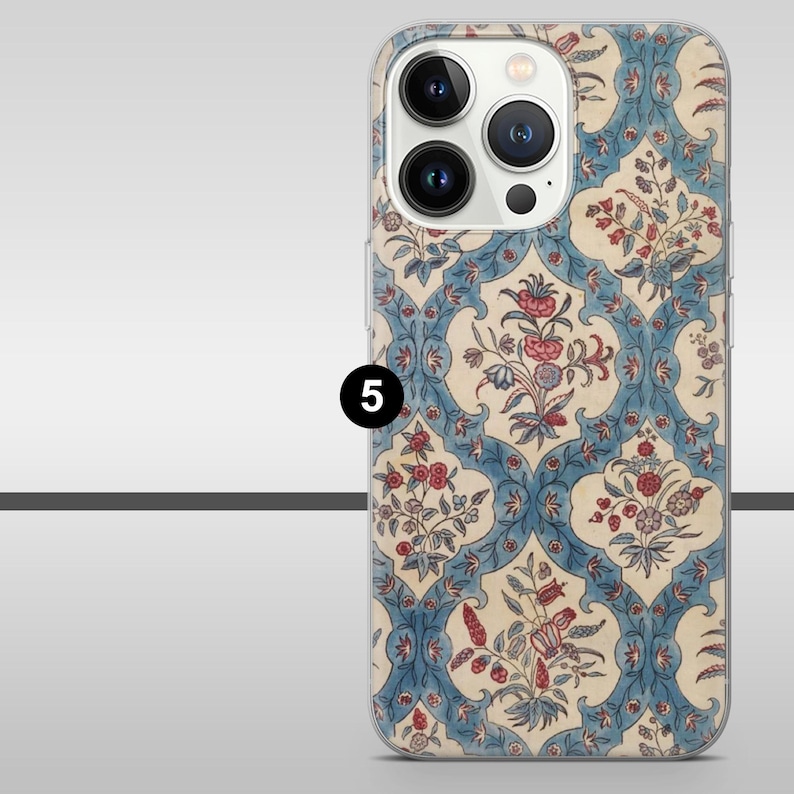 May include: A phone case with a floral design in blue, red, and cream. The pattern features stylized flowers and leaves in a repeating motif. The case has a clear border and a camera aperture.