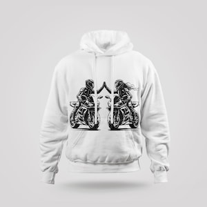 May include: White hoodie with a black and white graphic of two people riding motorcycles. The people are facing each other and appear to be high-fiving.
