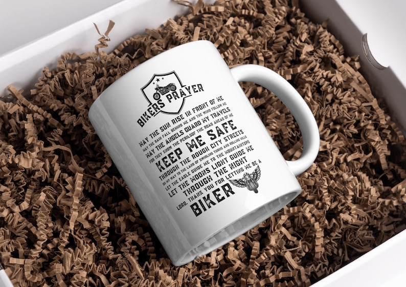May include: White ceramic mug with a black design that reads "Bikers Prayer" and includes a motorcycle graphic. The text reads "May the sun rise in front of me, may the rain fall behind me, may the angels guard my travels, for they know the perils of the road ahead of me. Keep me safe through the rough city streets, in the way of the land of Brooklyn, and million hills. Let the cable guide me to the mountain tops. Let the moon's light guide me through the night. Lord, thank you for letting me be a biker."