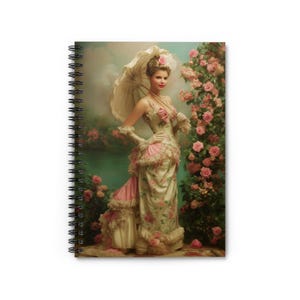 May include: A spiral-bound notebook featuring an illustration of a person in a cream-colored gown with pink floral patterns, ruffles, and white gloves, holding a matching parasol while standing beside a tall bush of pink roses near a pond.