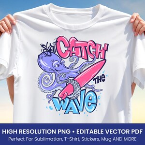 May include: White t-shirt featuring a cartoon octopus surfing on a pink surfboard. The octopus is purple with blue tentacles. The text "Catch the Wave" is in pink and blue. The shirt is held up by hands.