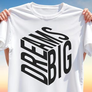 Camiseta tipográfica 3D "Sueños Grandes" PNG: diseño de camiseta con frase motivacional para sublimación, variantes arcoíris y negro, arte moderno con letras cúbicas.