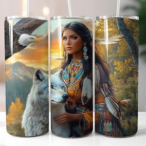 May include: Three stainless steel tumblers with different designs. The first tumbler features a bald eagle with a sunset background. The second tumbler features a Native American woman with a wolf and a feather headdress. The third tumbler features a Native American woman with a feather headdress and a sunset background.