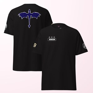 May include: Black t-shirts with a dragon graphic on the back and the word "RIORSON" on the front. The dragon is dark blue with white outlines. The shirts have short sleeves and a crew neck.