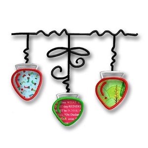 May include: Three red and green Christmas light ornaments with white trim hang from a black wire. The ornaments are decorated with a blue and white pattern of stockings, a green and white pattern of a Christmas tree, and a red and white pattern with text that reads "Then WHAT to EI HT tiny REINDEF M. ST be St. Nick! A VED, "On Dasher EER soon me".