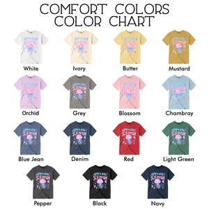 May include: A color chart of Comfort Colors t-shirts in various shades, including white, ivory, and black. Each shirt features a jellyfish graphic with the text "Blow a Kiss Jellyfish". The chart displays a range of colors, from pastels to darker hues.