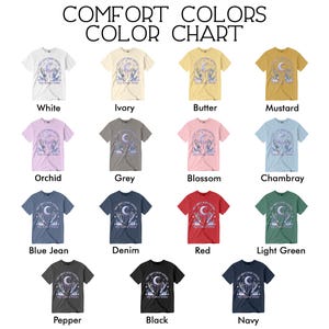 May include: A color chart of Comfort Colors t-shirts in various shades, including white, ivory, butter, mustard, orchid, grey, blossom, chambray, blue jean, denim, red, light green, pepper, black, and navy. Each shirt displays a graphic design.