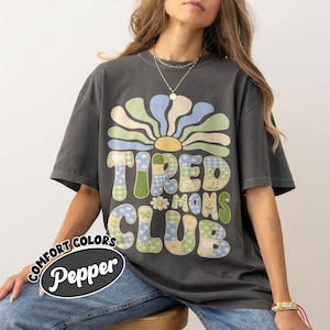 May include: A white ceramic mug with a black handle and the text "But First, Coffee" in a handwritten style. The mug is on a white surface. The mug is 4 inches tall.