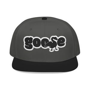 May include: A charcoal gray baseball cap with a black flat brim and a top button. The front features an embroidered white and black patch displaying the word goose, where the letter s is replaced by a black silhouette of a goose bird.