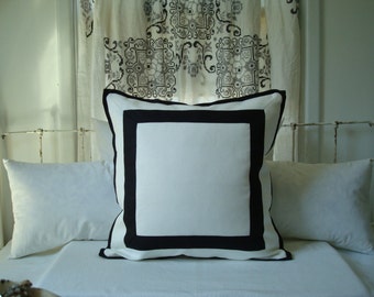 white pillows with black trim